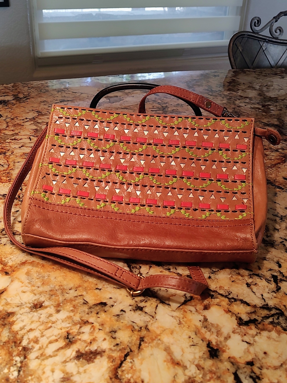 The Sak Tan Leather Crossbody with Orange and Lime Woven Punch Accents